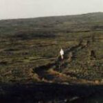 Susanna hiking in a lava field.